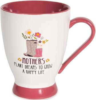 White mug with tomato red base, handle, and interior. Illustration on mug of large grey rain boots with white polka dots next to small pink rain boots, with flowers sticking out of the boots. Text under illustration reads "Mothers Plant Dreams To Grow A Happy Life."