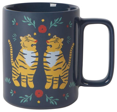 Black mug with illustration of two tigers facing each other and red flowers, green leaves, and yellow stars. 