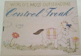 Lid of vintage style tin box with illustration of cartoon donkey in a field measuring a flower against a ruler. Donkey has bow on head and pencil behind ear. Text at top reads "World's Most Outstanding" in green and "Control Freak" in blue. 