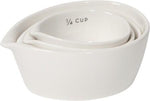 Set of 4 nested white stoneware measuring cups.