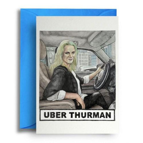 Card on top of sky blue envelope. Card is white with illustration of Uma Thurman at the wheel of a car. Text underneath reads "Uber Thurman."